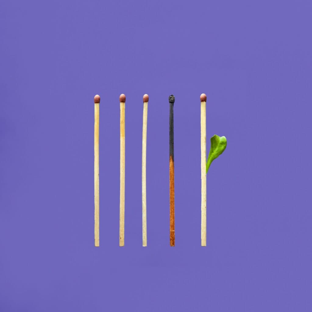 "Burnout" represented by 5 matches, one of which has burnt and one which is growing a leaf representing the ability to recover from burnout.